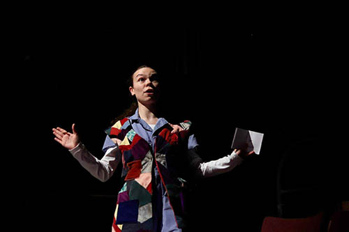 IMAGE #27 – production shot, actor reading book in bright multi- coloured jacket copy